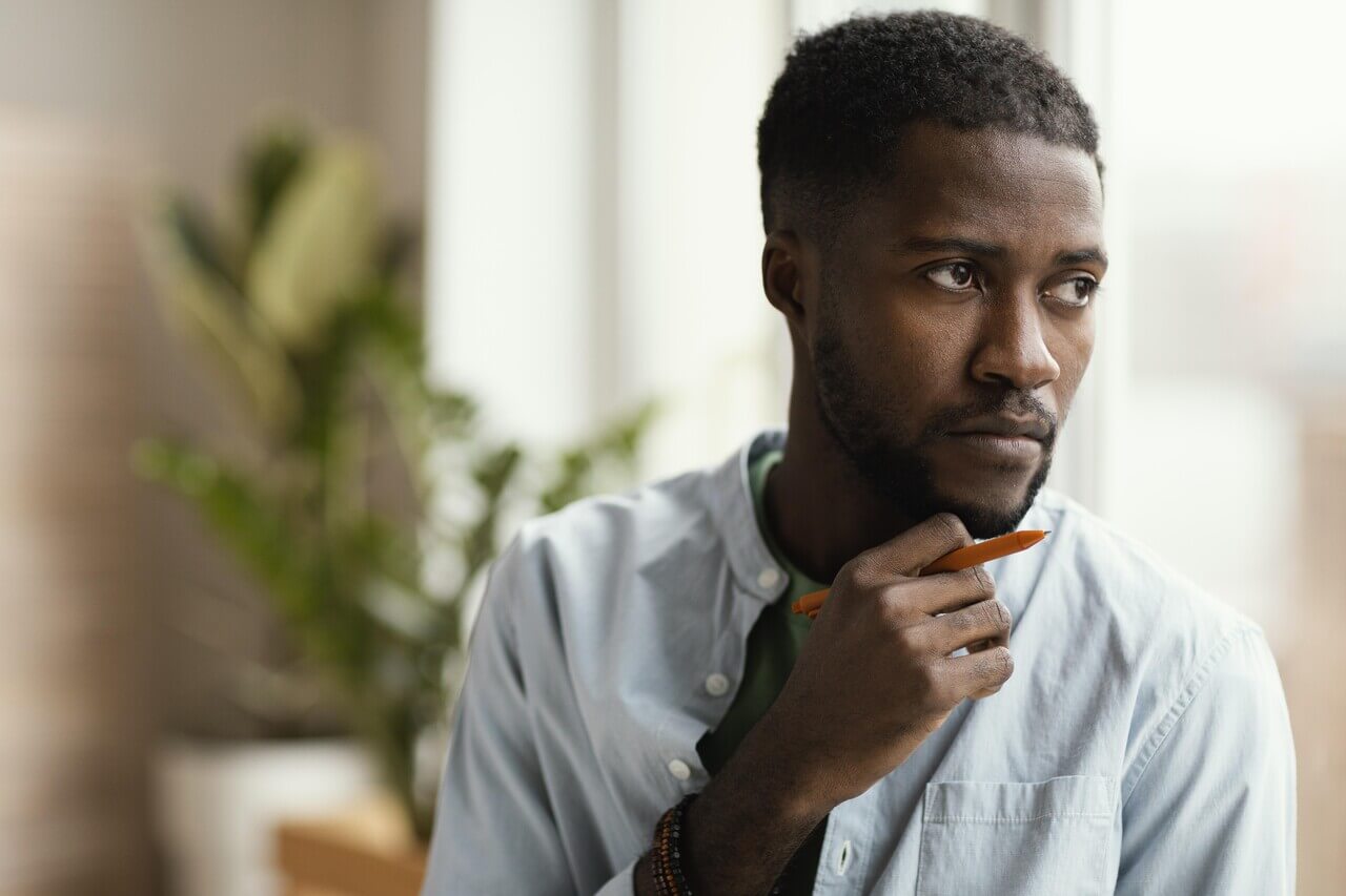 Man making plans and thinking about how to close the Confidence Gap