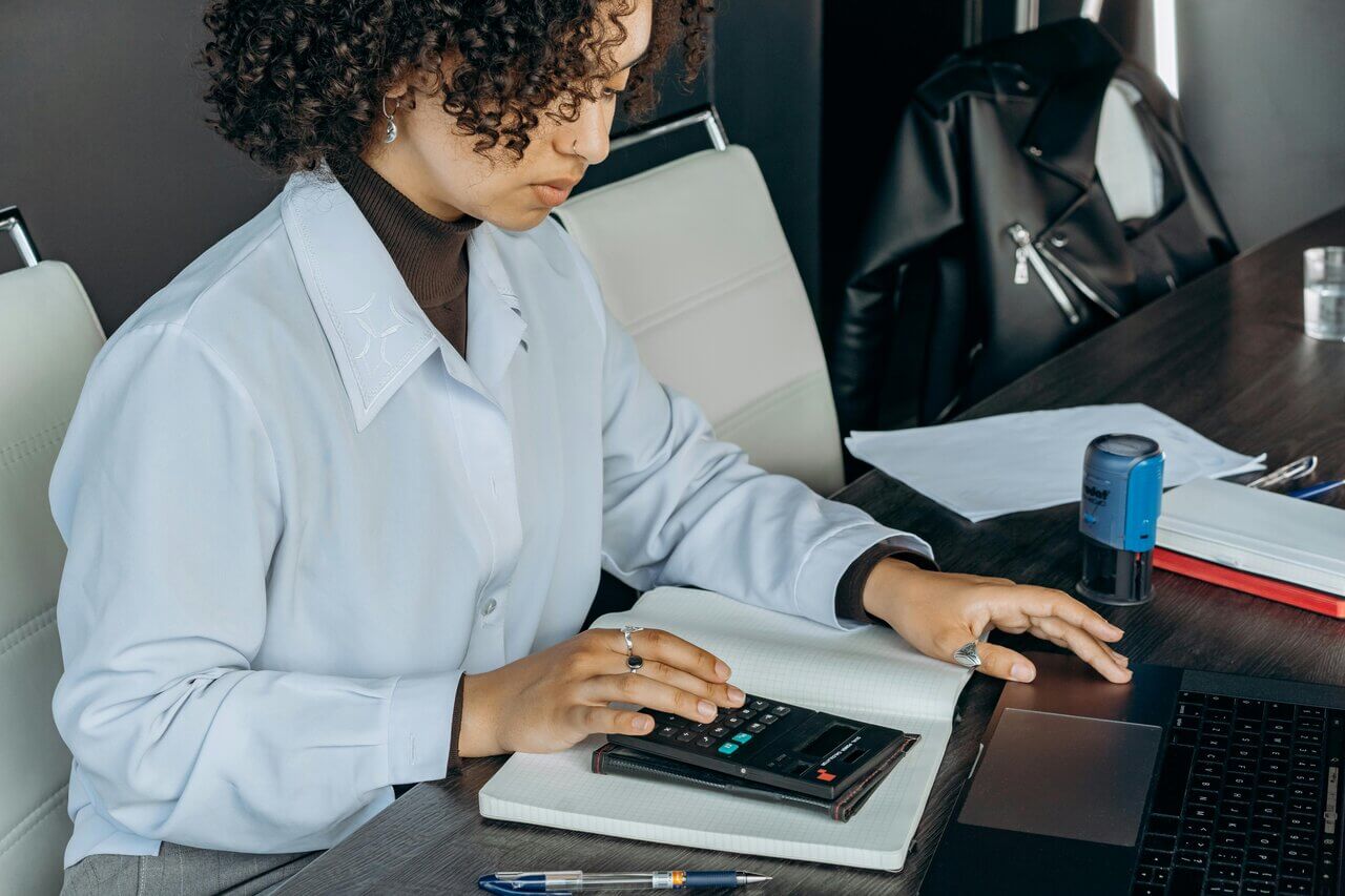 Female accountant calculating at her desk