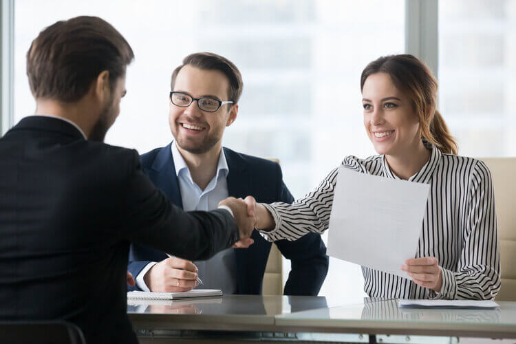 HR handshake with employee during interview
