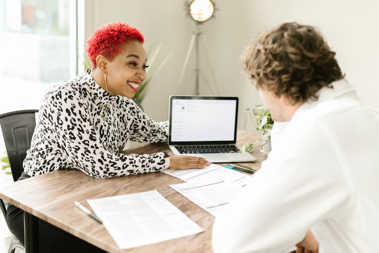 Female financial advisor sitting in a meeting with a male client